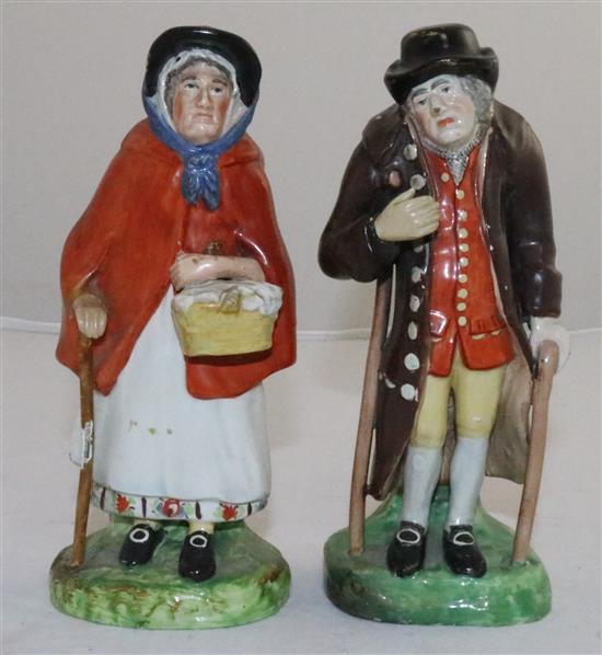 A pair of Staffordshire pearlware figures of an elderly lady and gentleman, c.1830, height 18cm (7.1in.), restorations